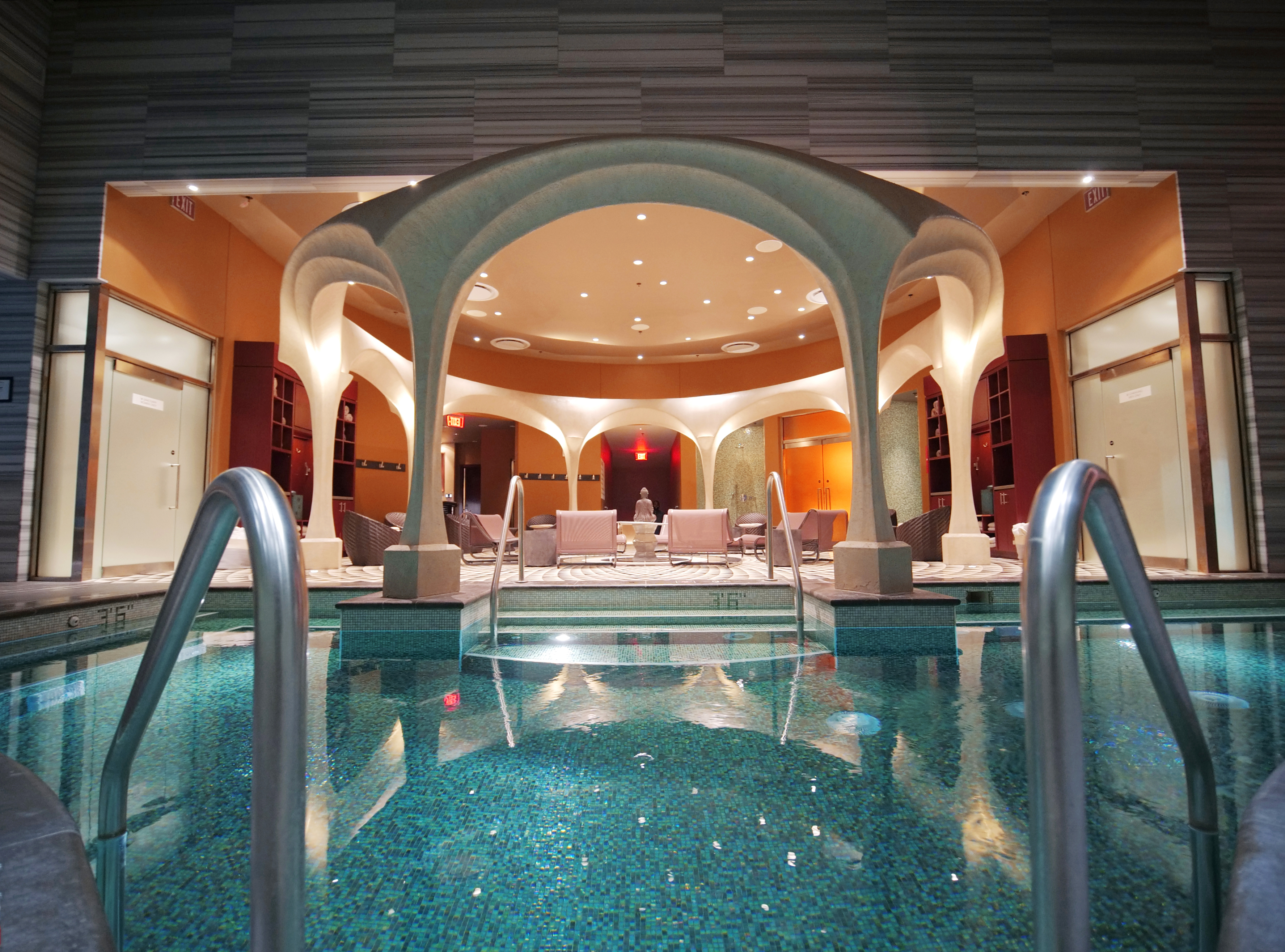 Indoor spa bathhouse at Ocean Casino Resort featuring a tranquil pool and stylish lounge seating under elegant archways.