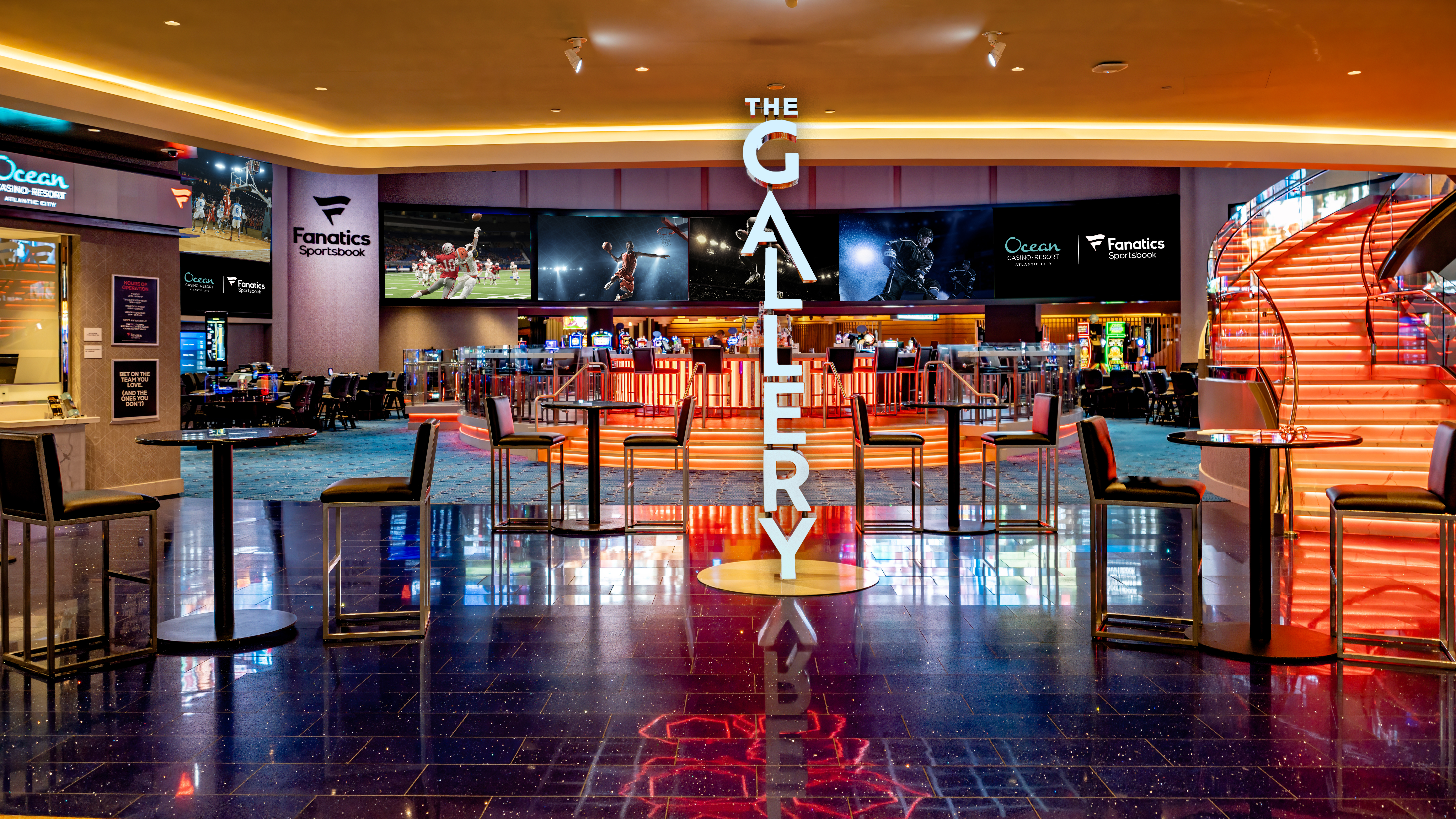 The Gallery at Fanatics Sportsbook inside Ocean Casino Resort, with large LED screens, bar seating, and a vibrant sports-watching atmosphere