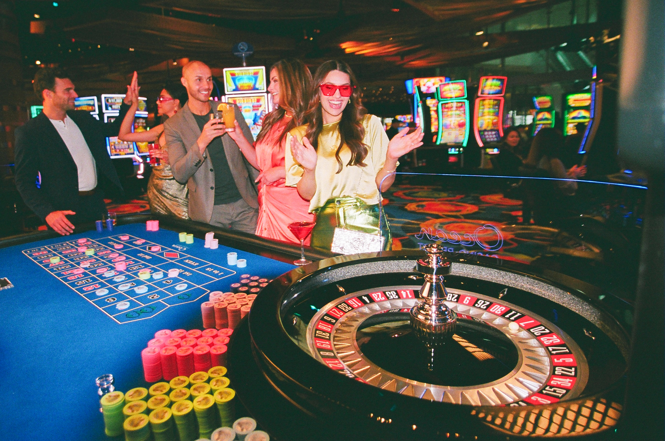 A group of friends cheer around a roulette table at Ocean Casino Resort, watching the ball spin with anticipation.