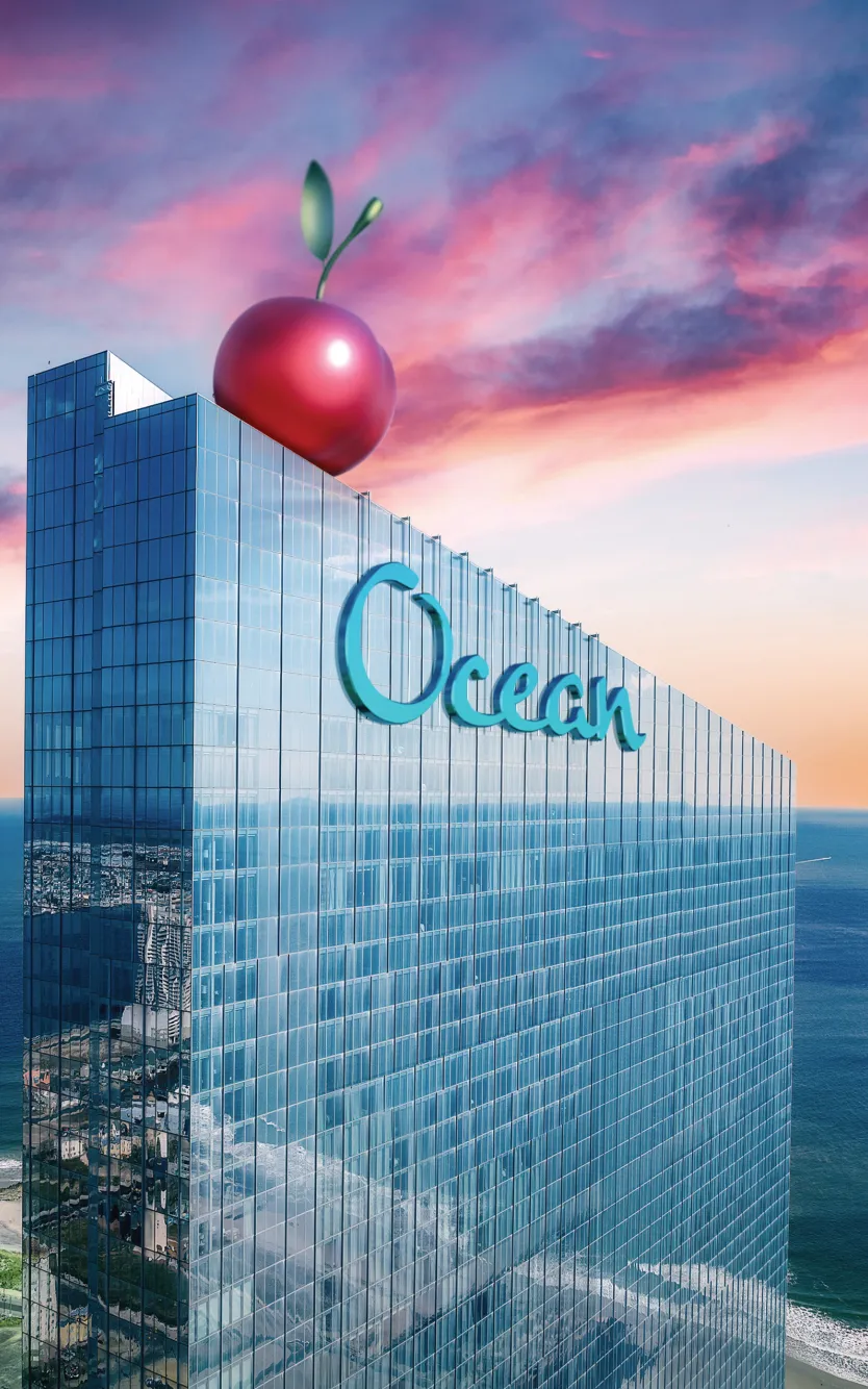 Ocean Casino Resort with giant cherry on rooftop at sunset, celebrating its 7th birthday in Atlantic City.