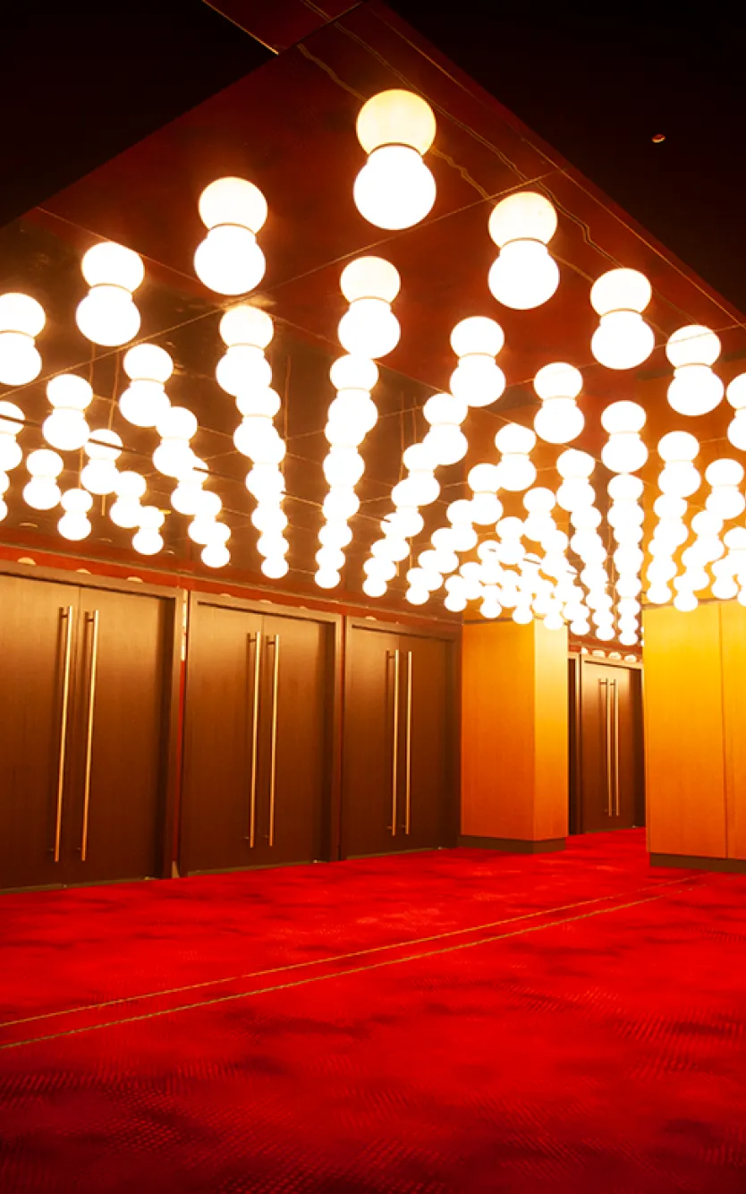 Entrance to Ovation Hall at Ocean Casino Resort in Atlantic City, featuring red carpet flooring and marquee-style ceiling lights.