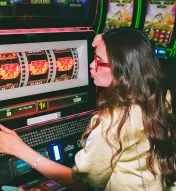 Girl kissing slot machine for good luck