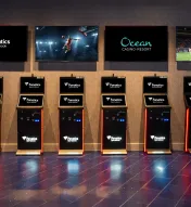 Fanatics Sportsbook self-service betting kiosks at Ocean Casino Resort with live sports displayed on overhead screens for easy in-person wagering.