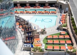 Aerial view of HQ² Dayclub at Ocean Casino Resort, featuring a sparkling pool surrounded by orange loungers and private cabanas.
